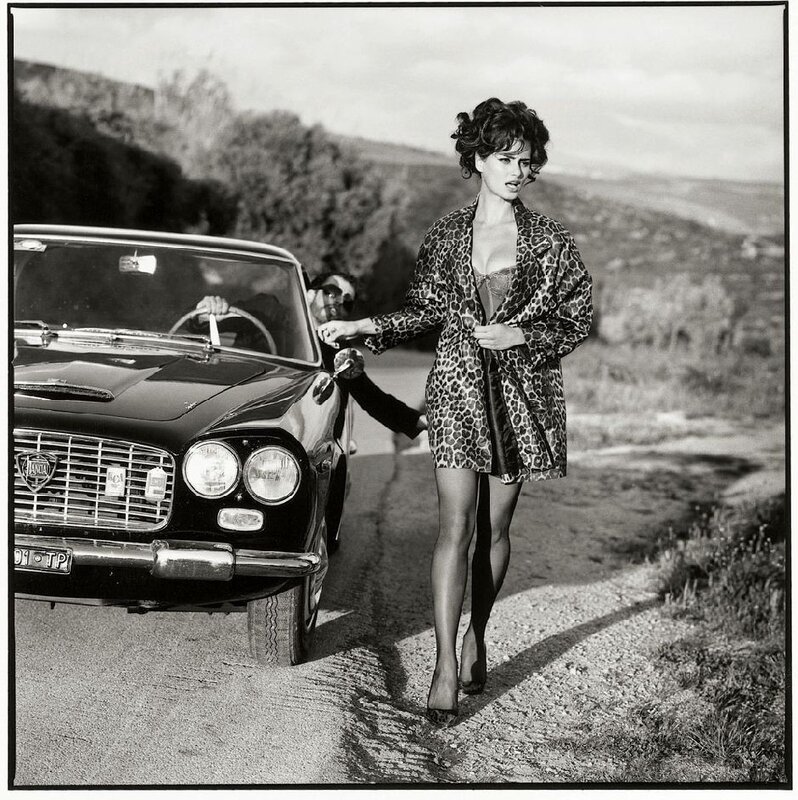 Woman in leopard coat by car