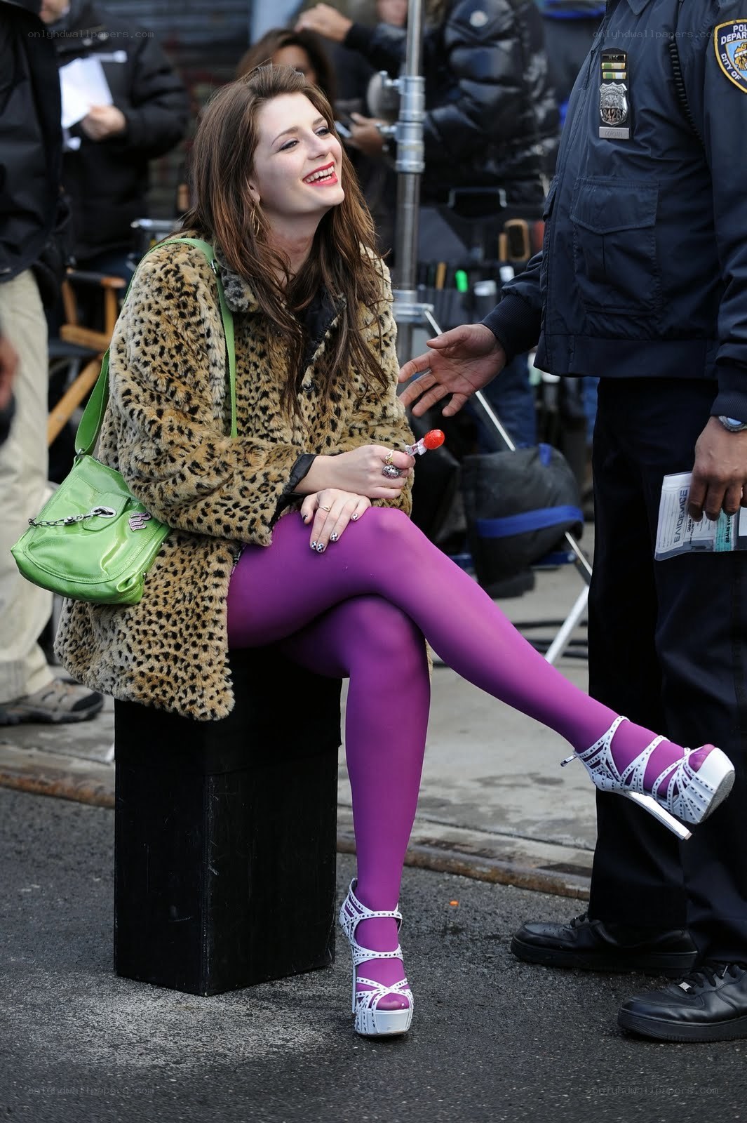 Woman in leopard coat on set