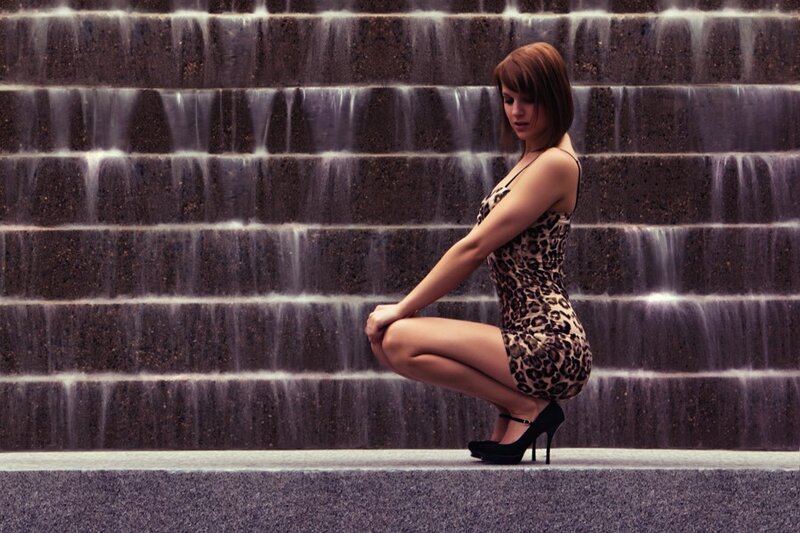 Woman in leopard dress by waterfall