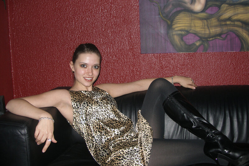 Woman in leopard dress on couch