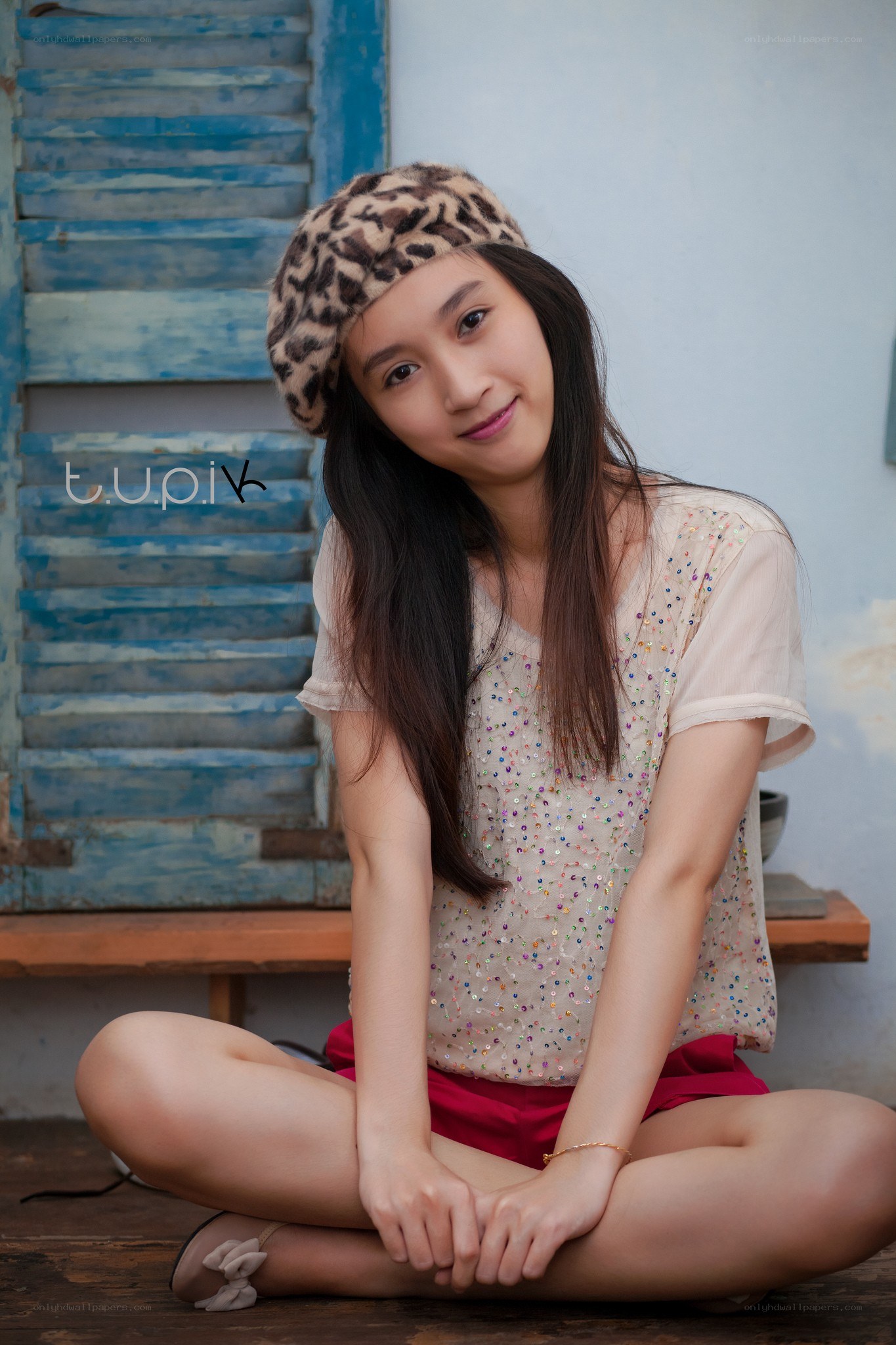 woman in leopard hat sitting