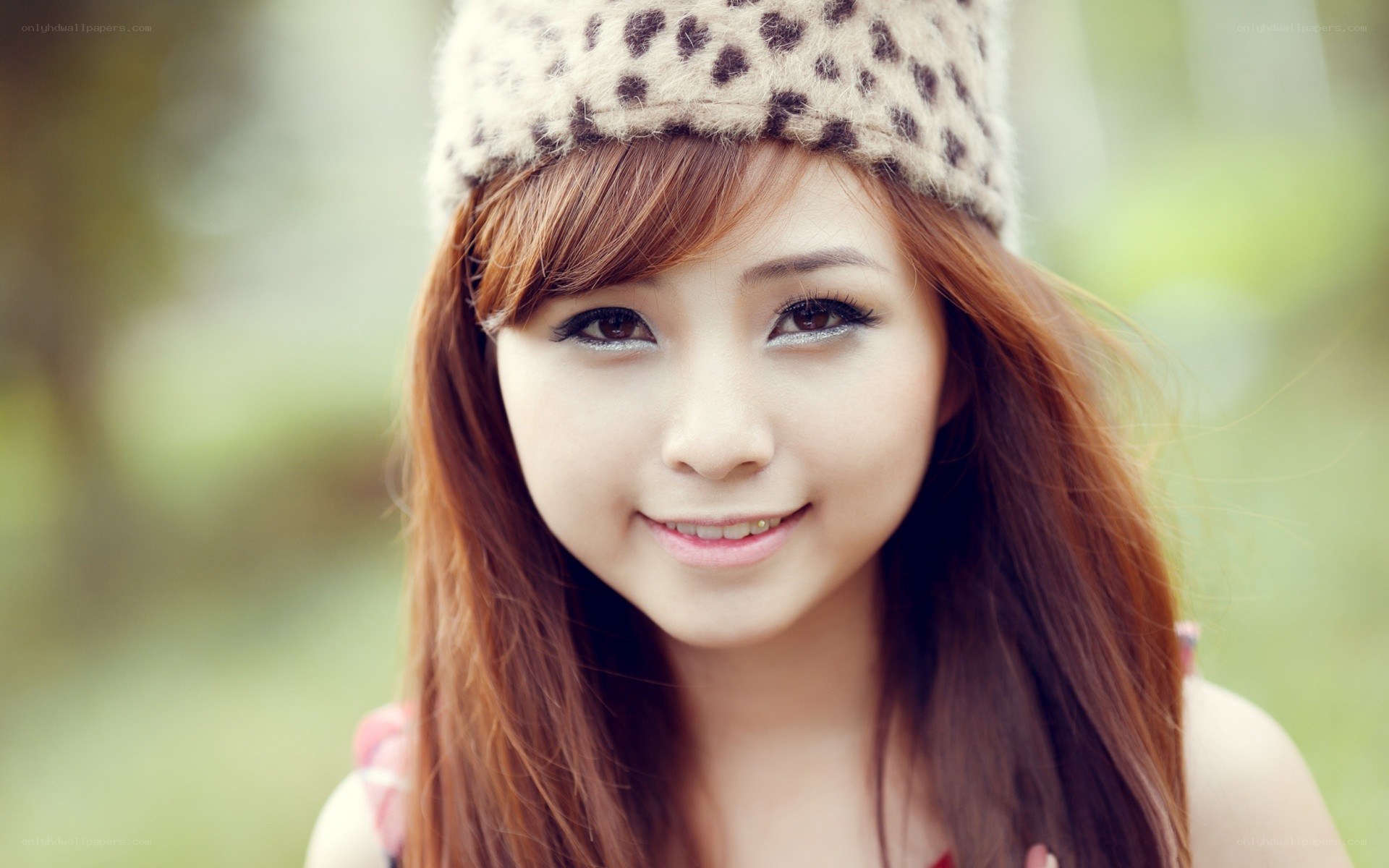 woman in leopard hat smiling