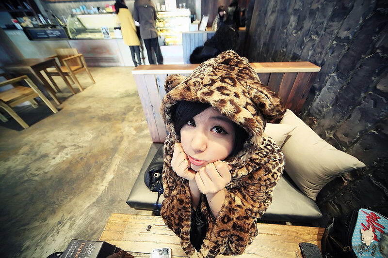 Woman in leopard hoodie at cafe