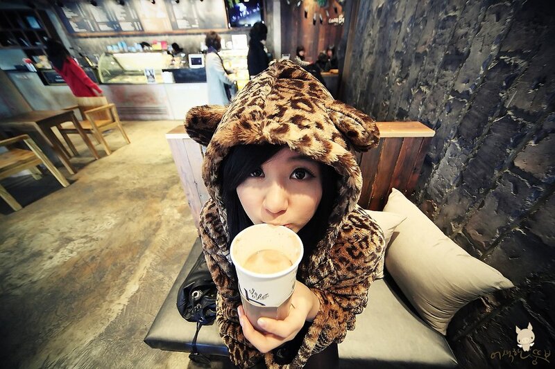Woman in leopard hoodie with coffee