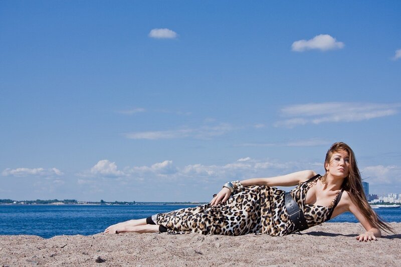 Woman in leopard print dress on beach