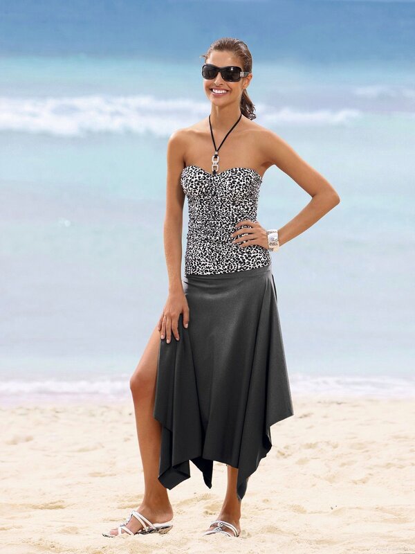 Woman in leopard top on beach