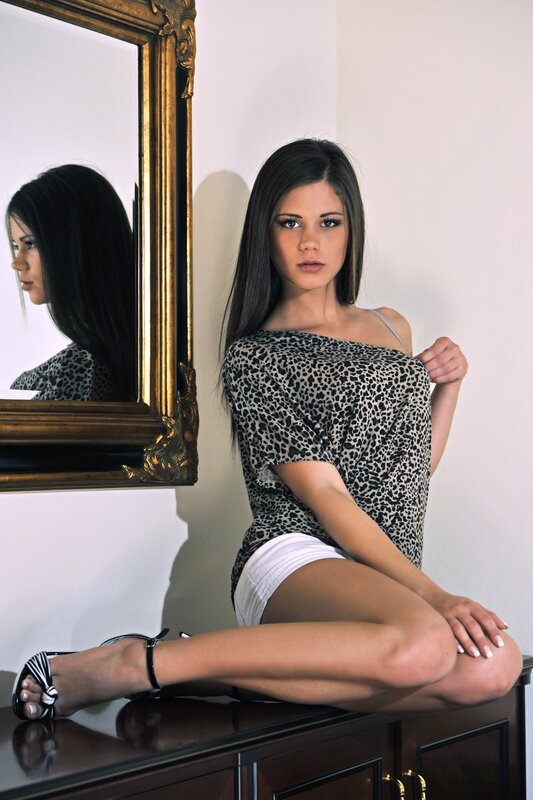 woman in leopard top sitting