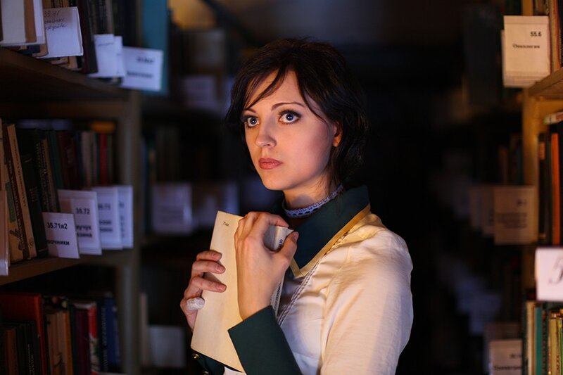 woman in library holding book
