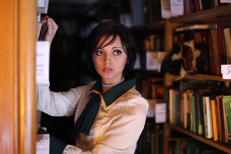 woman in library selecting book