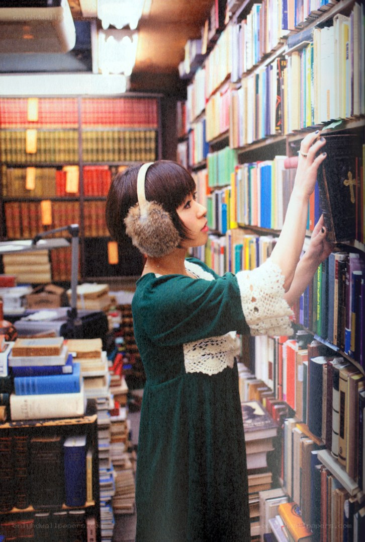 woman in library selecting book