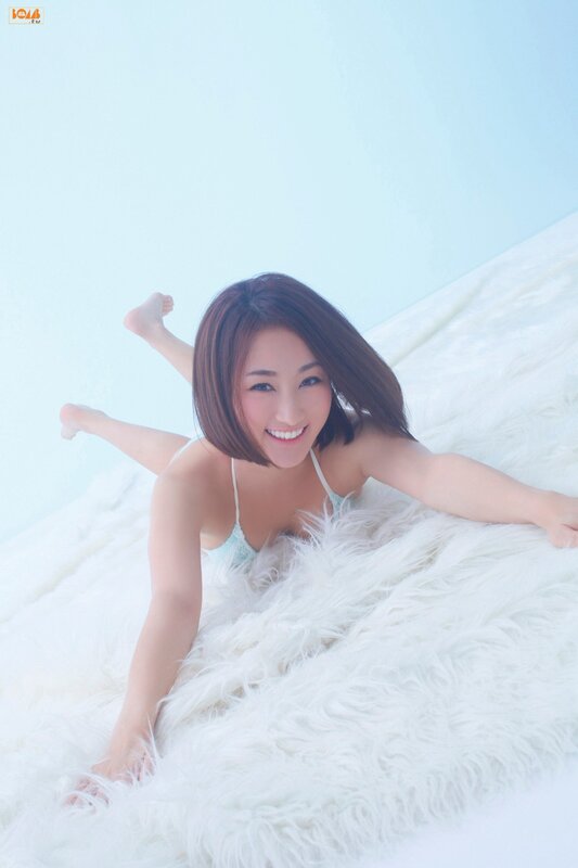 woman in light blue top on white rug