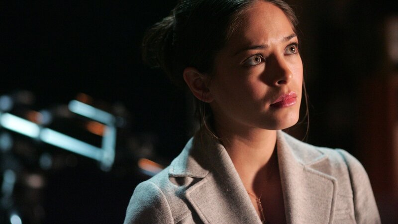 woman in light coat looking away