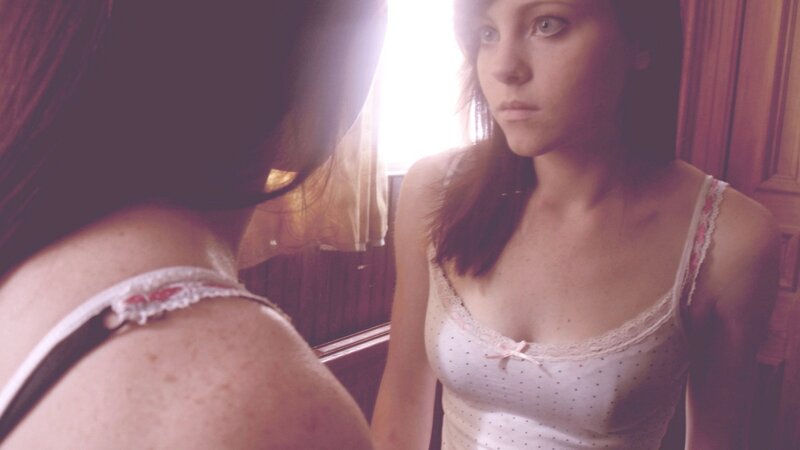 woman in lingerie looking at mirror