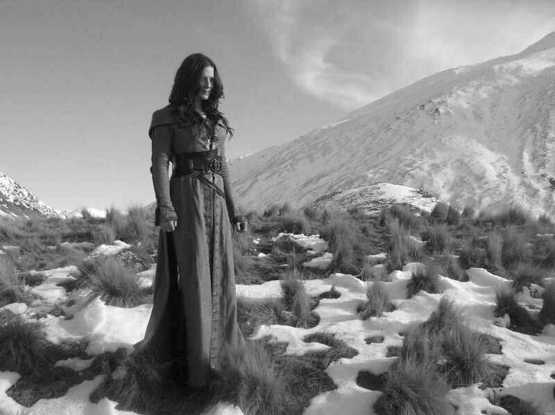 woman in long dress on snowy hill