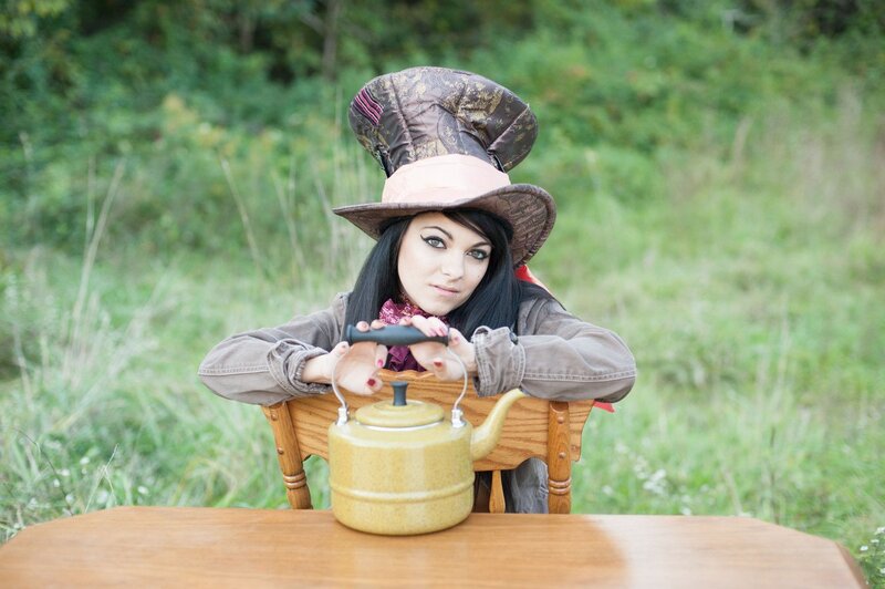 Woman in Mad Hatter hat with kettle