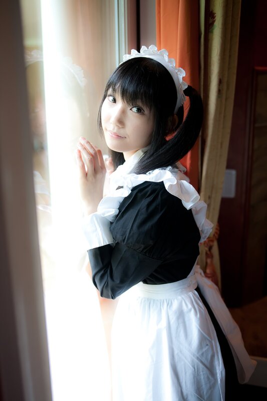 woman in maid costume by window