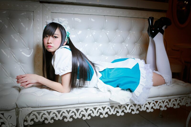 woman in maid costume on bench