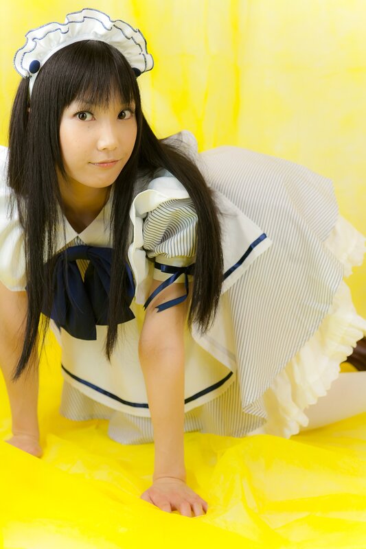 woman in maid costume on yellow