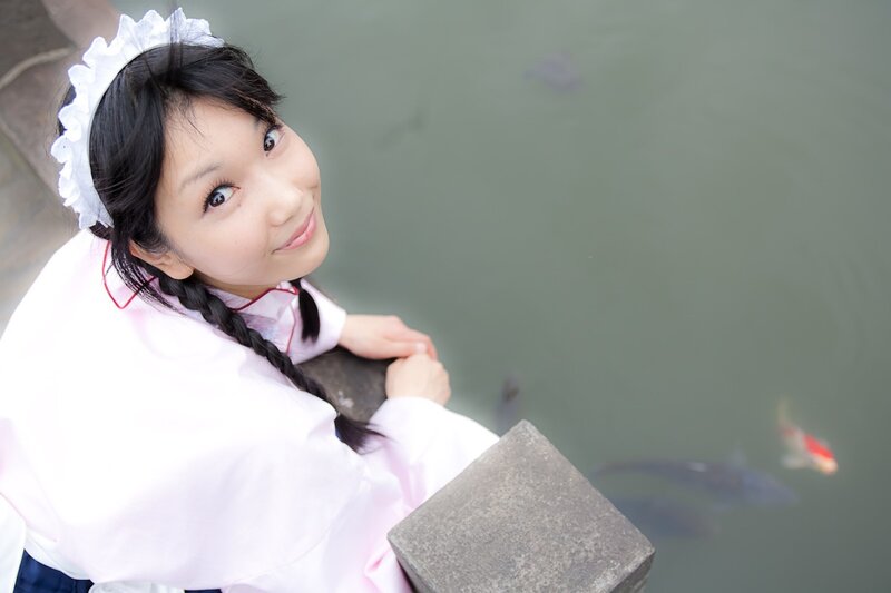 woman in maid outfit by pond