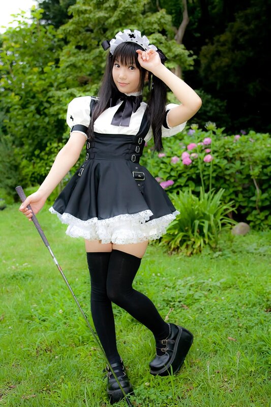 Woman in maid outfit holding golf club