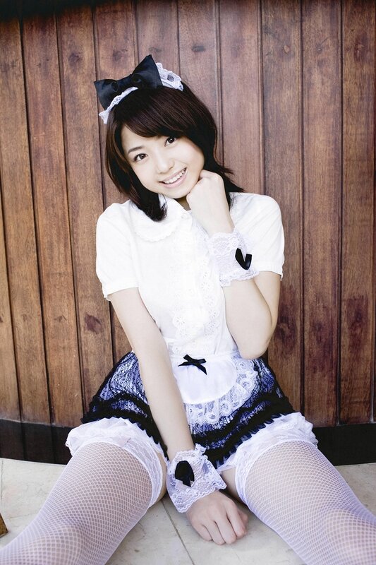 woman in maid outfit smiling