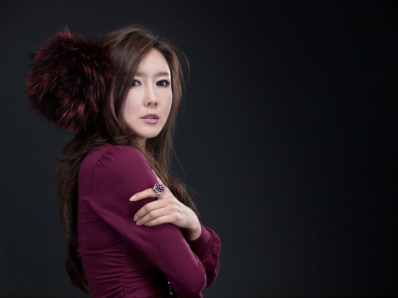 woman in maroon top with fur accessory