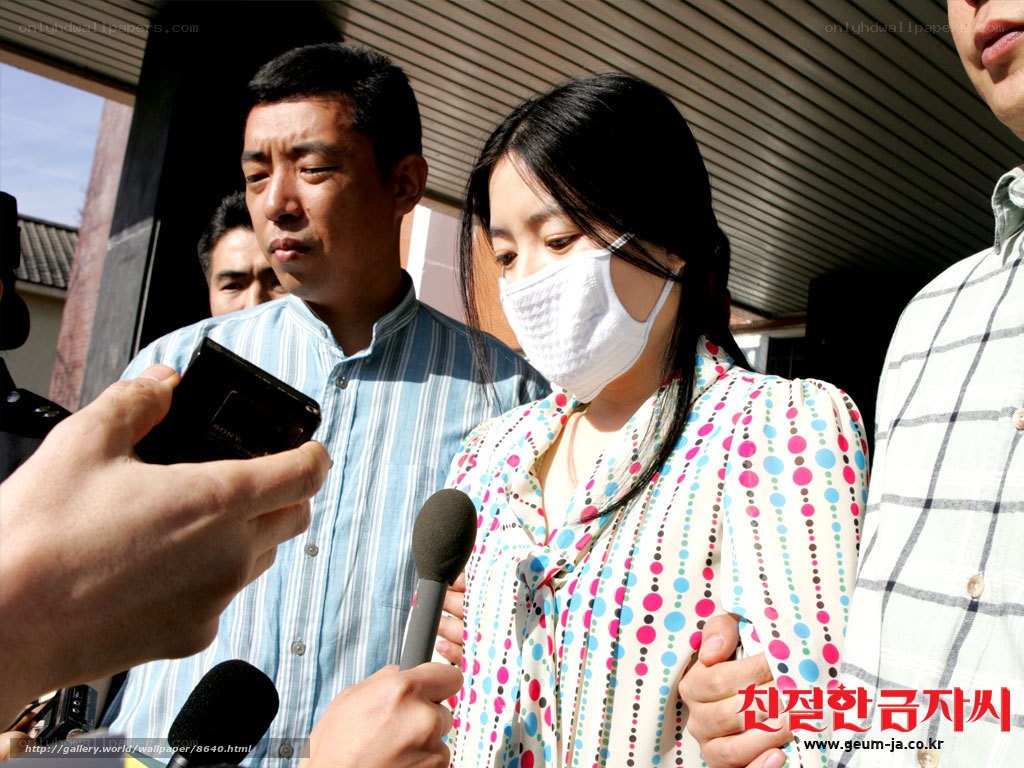 woman in mask speaking to press