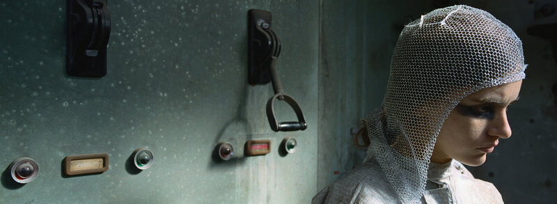 woman in mesh hood near control panel
