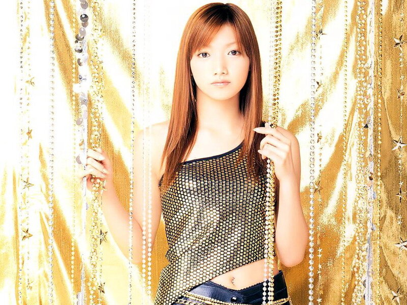 woman in mesh top with gold backdrop