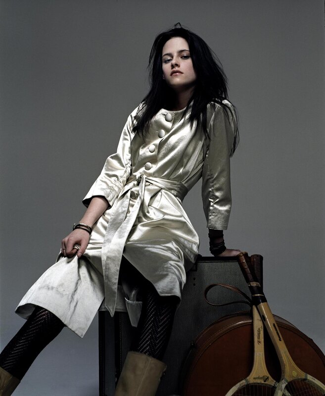 woman in metallic coat sitting