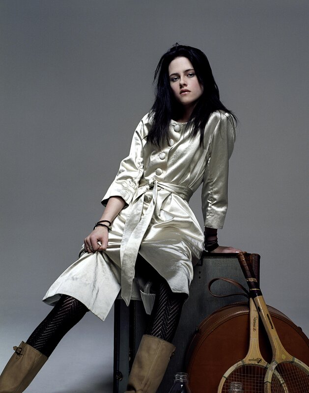 woman in metallic coat sitting