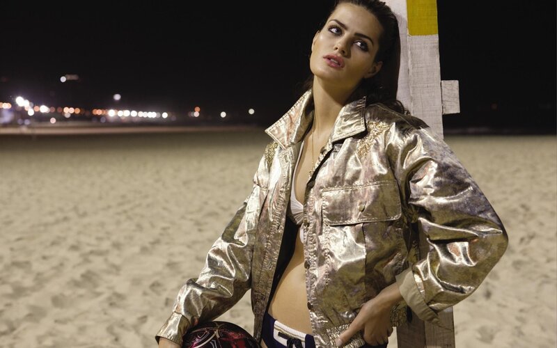 woman in metallic jacket at night