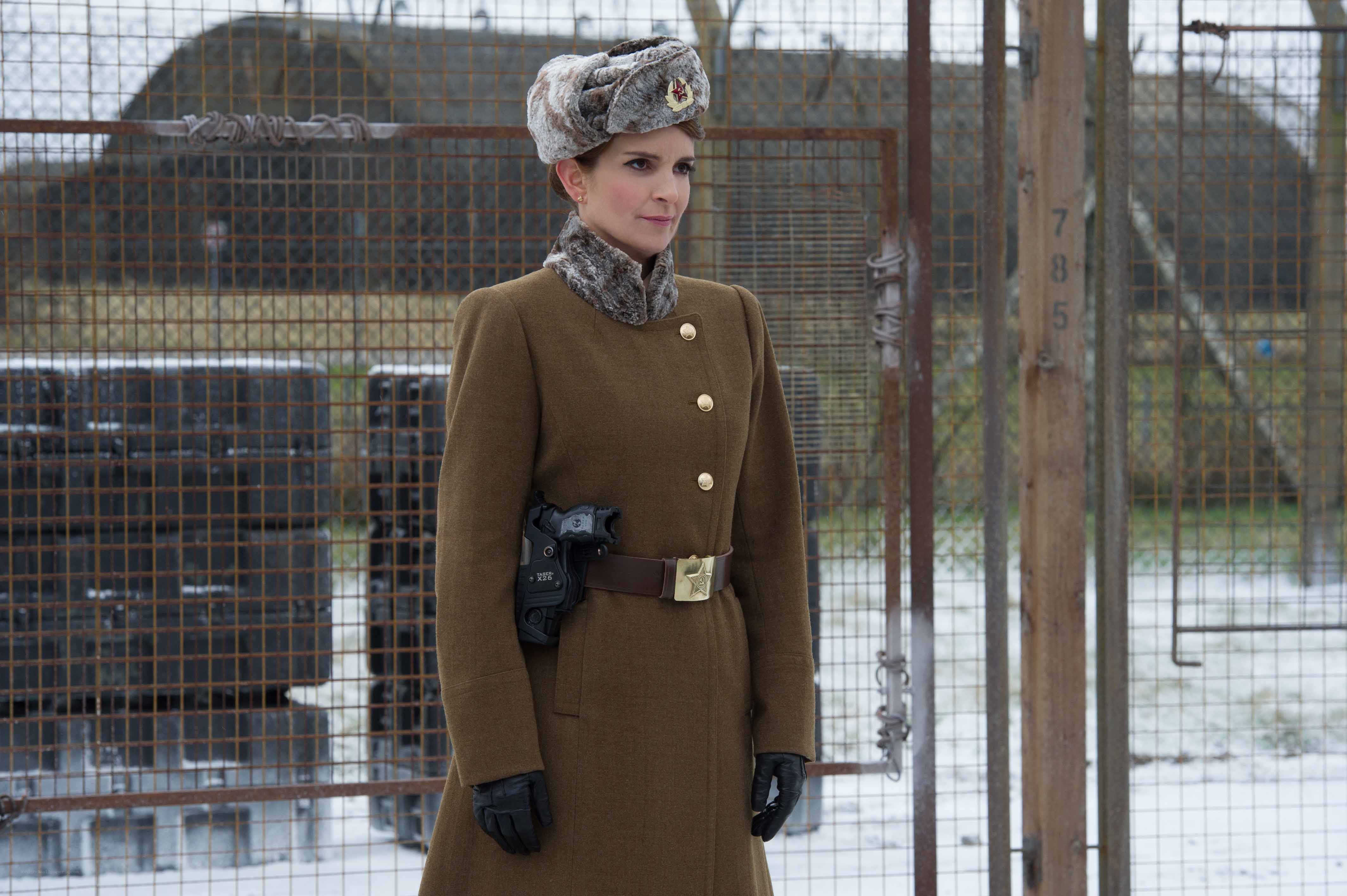 Woman in military coat with gun