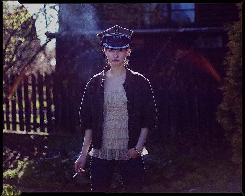 woman in military-style hat