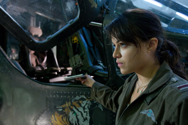 Woman in military uniform near helicopter