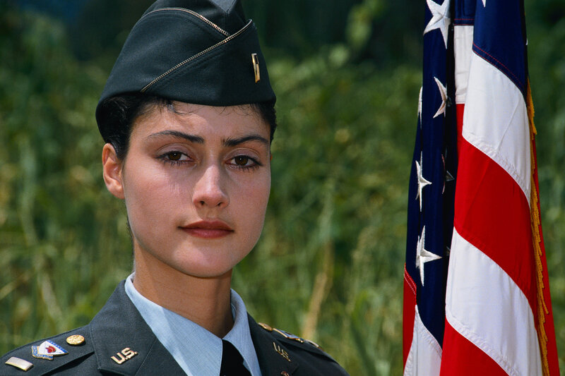 woman in military uniform with flag