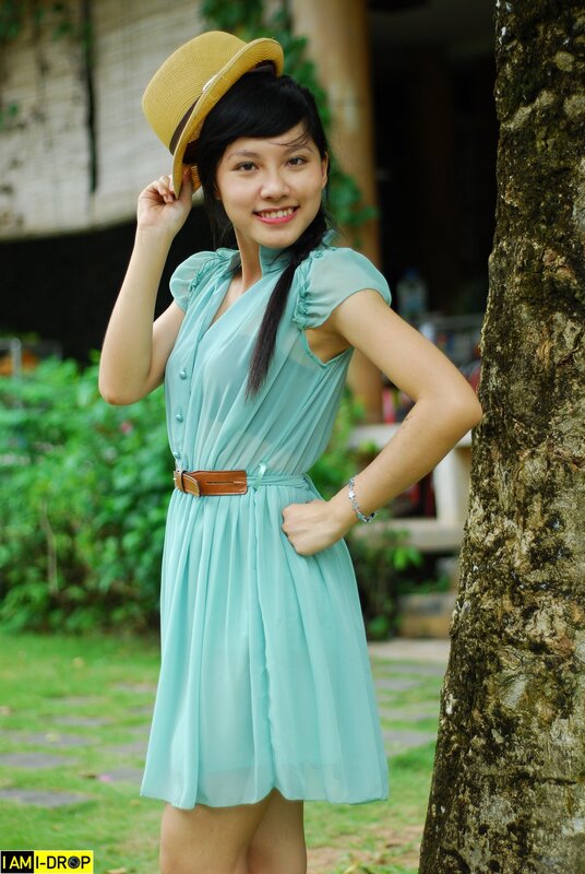 Woman in mint dress and hat