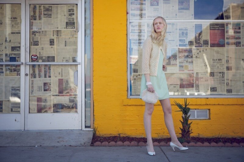 Woman in mint dress on sidewalk