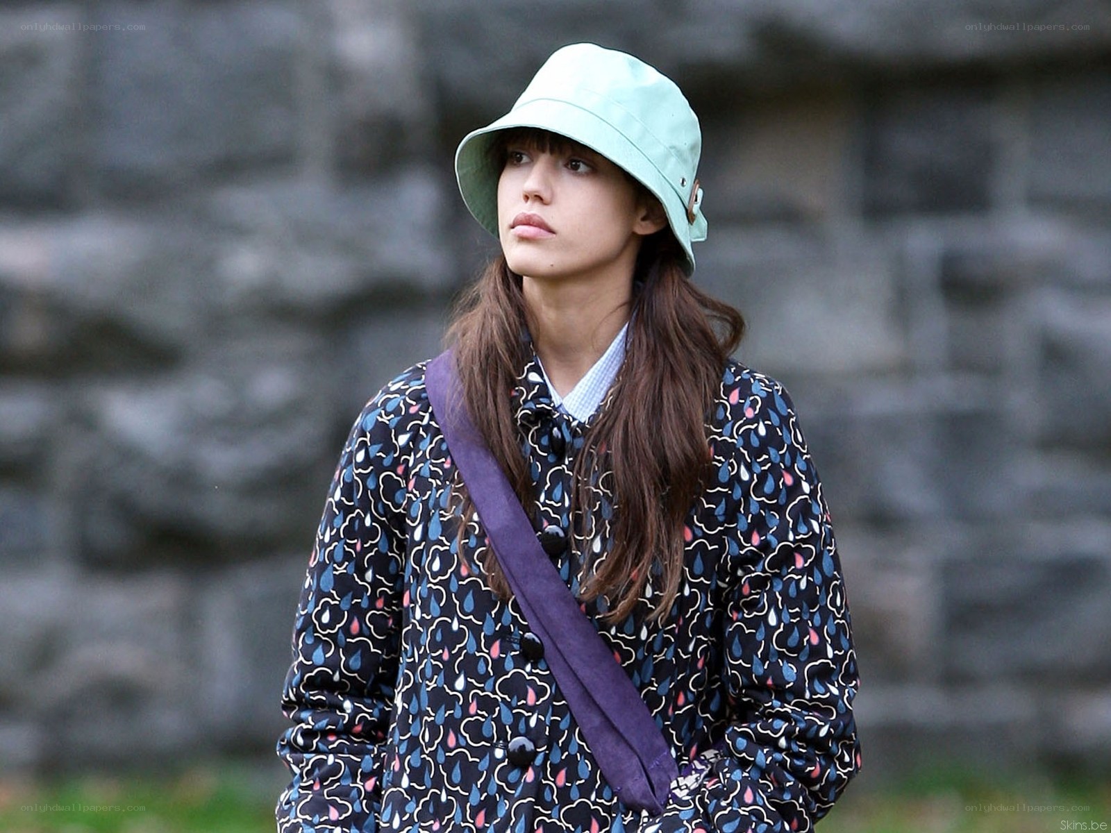 woman in mint hat and patterned coat