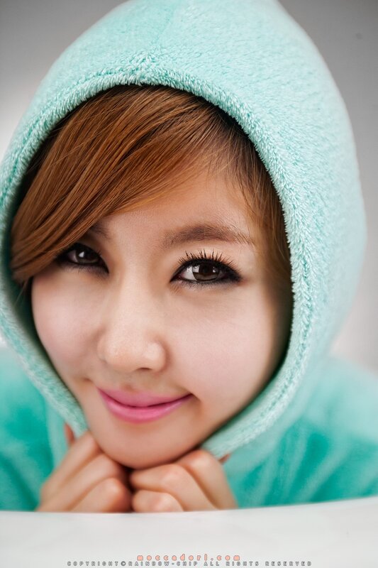 woman in mint hoodie smiling