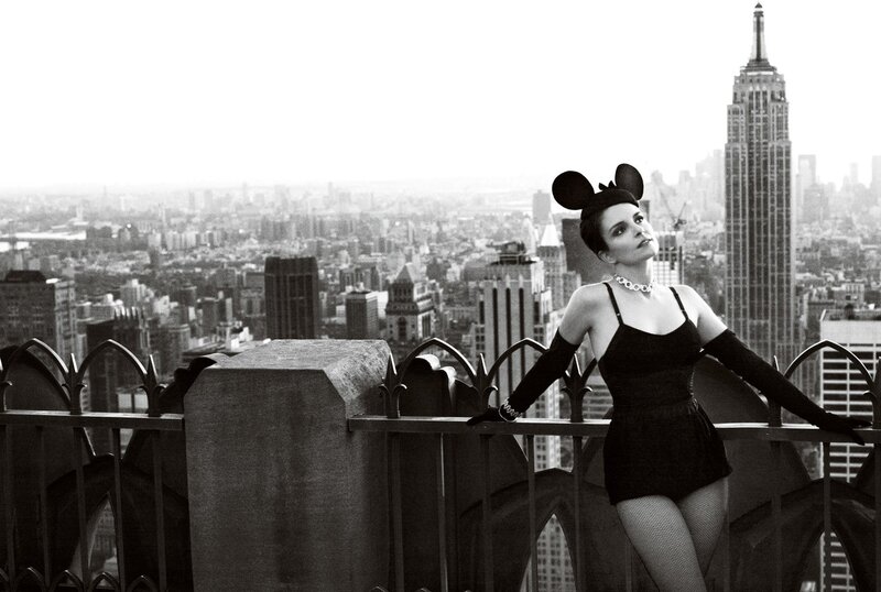 Woman in mouse ears on rooftop