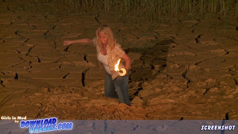 Woman in Mud Holding Torch