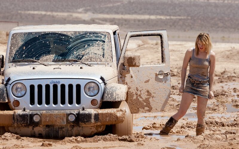 Woman in Mud Next to Jeep