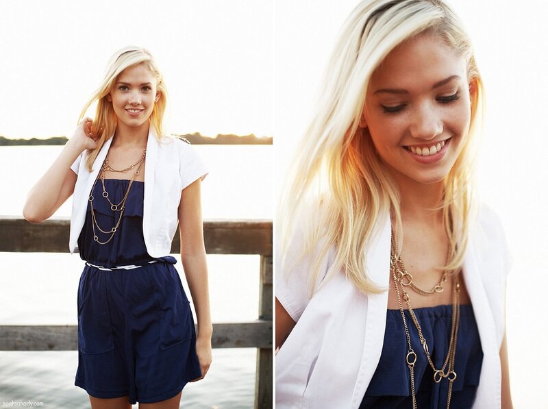 woman in navy romper smiling