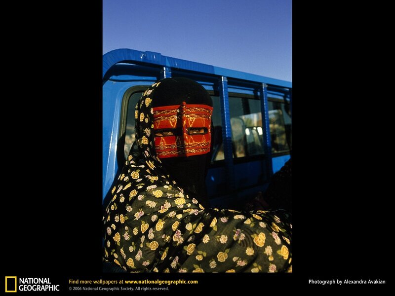 Woman in niqab near blue vehicle