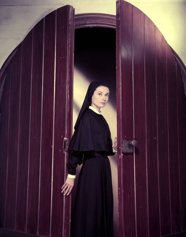 woman in nun's habit at door