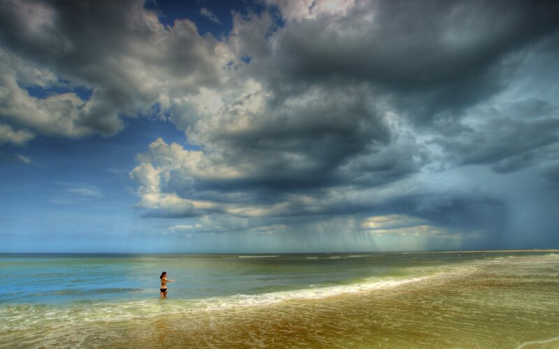 Woman in Ocean Water — Blue, Dramatic, Afternoon, Photograph, Clouds