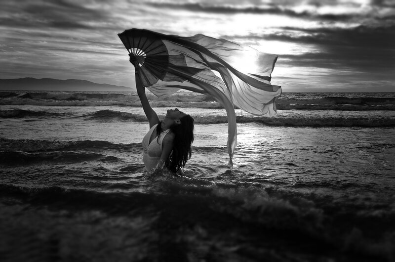 Woman in Ocean with Fan