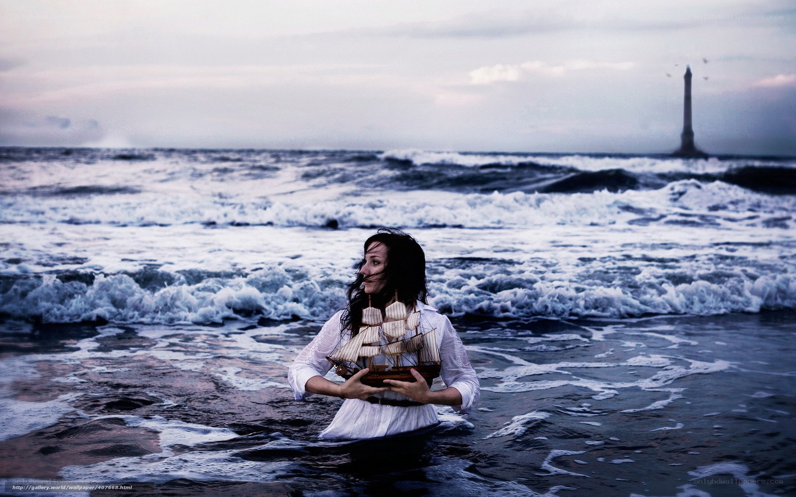Woman in ocean with ship model