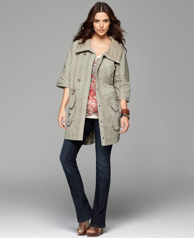 Woman in olive trench coat